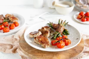 Read more about the article Pan-seared pork loin with bacon-wrapped green beans and baked tomatoes